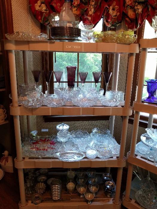 Bottom shelf has vintage ice cream shop dishes, next two shelves house a nice collection of American Brilliant Cut Glass bowls, low bowls, relish dishes and nappys. The top shelf has a neat collection of clear/yellow cut glass dessert set, a sterling overlay dessert set and more ABCG.