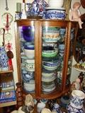 China cabinet filled with ceramic and blue wares