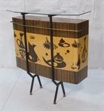 Lot 49:  Italian Bar with Decorative Urn Frieze detail. Heavy lacquered finish. Black metal trim & legs with brass elements. Glass shelf. : Dimensions:  H: 44.5 inches: W: 43 inches: D: 16.5 inches --- 