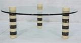 Lot 71:  Great Decorator Coffee Cocktails Table. Bone and Horn. Three Legged Glass Top Coffee Cocktail Table. Three striped column legs made of tessellated horn & bone bands. 1" thick round glass top.: Dimensions:  H: 19 inches: W: 49 inches: D: 49 inches --- 