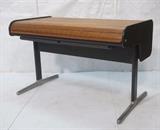 Lot 77:  HERMAN MILLER Roll Top Modernist Desk. Tambour Top. Office Action. Metal Reverse "T" Legs with aluminum feet. Hidden file compartment to top back. Marked: Dimensions:  H: 34 inches: W: 54 inches: D: 29.5 inches --- 
