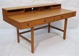Lot 84:  PETER LOVIG NIELSEN Modernist Teak Desk. Iconic form with flip back extension. : Dimensions:  H: 34.25 inches: W: 64 inches: D: 29 inches --- 
