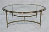 Lot 116:  Brass Tone & Glass Cocktail Coffee Table. Round table. Four ball finials. Regency style. : Dimensions:  H: 17 inches: W: 39 inches: D: 39 inches --- 