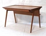 Lot 130:  RANDERS Modernist Danish Teak Desk. Raised back lip That angles down on sides. Two drawers. Rear bookshelf bookcase feature. Marked on bottom of one drawer: Made in Denmark,  Randers Mobelfabrik: Dimensions:  H: 28 inches: W: 45 inches: D: 28 inches --- 