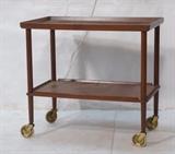 Lot 162:  Danish Modern Teak Rolling Trolley Bar Cart. Brass accents. Black laminate top. Marked: Dimensions:  H: 25.75 inches: W: 27.5 inches: D: 16.25 inches --- 