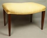 Lot 210:  Modernist Mid Century Walnut Bench Foot Stool. lightly bowed seat. Tapered square legs: Dimensions:  H: 16.5 inches: W: 24 inches: D: 17 inches --- 