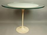 Lot 212:  KNOLL Assoc by EERO SAARINEN Side Tulip Table. Thick oval glass top has been added. KNOLL Label. : Dimensions:  H: 21 inches: W: 31 inches: D: 21 inches --- 