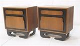 Lot 213:  Pr American Modern Night Stands. Single Ebonized door with raised Wood Panel elements. Unique foot form: Dimensions:  H: 25.25 inches: W: 24 inches: D: 17 inches --- 