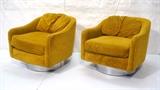 Lot 262:  Pr MILO BAUGHMAN style Gold Upholstered Swivel Lounge Chairs. Wide chrome base. Remnants of label. : Dimensions:  H: 27.5 inches: W: 29 inches: D: 32 inches --- 