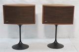 Lot 225:  Pr Modernist BOSE Standing Stereo Speakers. Walnut cases. Black metal tulip style bases. : Dimensions:  H: 30.5 inches: W: 21 inches: D: 13 inches --- 