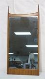 Lot 227:  WIDDICOMB Hanging Wall Mirror. Modernist Mid Century. Bowed top with tapered finials. Label: Dimensions:  H: 52.5 inches: W: 25.5 inches --- 