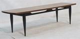 Lot 230:  Ebonized Base Wood Top Coffee Table. Gio Ponti style. Modernist cocktail table with bowed edges. Not marked: Dimensions:  H: 15 inches: W: 55 inches: D: 17 inches --- 