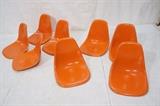 Lot 237:  Set 8 CHARLES EAMES for HERMAN MILLER Fiberglass Shells. All Orange fiberglass. Molded mark with sticker. : Dimensions:  H: 18 inches: W: 18 inches: D: 15 inches --- 