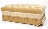 Lot 239:  Contemporary Decorator Tufted Tan Velvet Long Bench Foot Stool. Tufted fabric top. Contrasting plaid trim with decorative tassels and skirt.: Dimensions:  H: 18 inches: W: 48 inches: D: 24 inches --- 