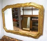 Lot 240:  Gold gilt mirror, distressed with red showing through. Leaf decoration.: Dimensions:  H: 38 inches: W: 54 inches --- 