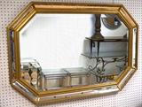 Lot 241:  Gold gilt mirror. Beveled mirror in gilt wood frame with mirror details. : Dimensions:  H: 34 inches: W: 49 inches --- 