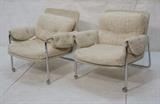 Lot 253:  Pr 70's Modern Tubular Chrome Lounge Chairs. On Rollers. Cream textured fabric with upholstered arms. : Dimensions:  H: 28 inches: W: 24.5 inches: D: 26 inches --- 
