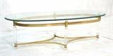 Lot 351:  Oval Glass Cocktail Table. Brass Frame with Lucite Legs.  Modernist Coffee Table.  Hollis Jones Style.: Dimensions:  H: 17 inches: W: 55 inches: D: 23 inches --- 