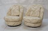 Lot 392:  Pr MILO BAUGHMAN for THAYER COGGIN Swivel Lounge Chairs. Cream patterned fabric on round channel upholstered backs. On Chrome base. Two toss pillows. Label. Height of seat is 15.5" high. : Dimensions:  H: 32 inches: W: 30 inches: D: 33 inches --- 