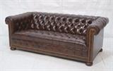 Lot 415:  Brown Leather Chesterfield Sofa Couch. Wood bun feet. Tufted with metal studs.: Dimensions:  H: 29 inches: W: 74 inches: D: 35 inches --- 