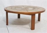 Lot 469:  Danish Teak Round Ceramic Tile Top Coffee Table. Possibly signed to one tile. : Dimensions:  H: 17 inches: W: 43 inches: D: 43 inches --- 