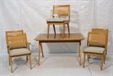 Lot 475:  6pc Dining Set. Table & 5 Chairs. Jens Risom style. Two arms; three side chairs. Banded table with scissor style legs. Caned back chairs. Arm chairs have brass rod elements. Table has pop out hidden leaf: Dimensions:  H: 28.5 inches: W: 49.25 inches: D: 32 inches --- 