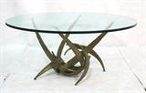 Lot 484:  SILAS SEANDEL style Welded Metal Brutalist Coffee Table. 3/4" glass top. Gold finish base. not marked: Dimensions:  H: 22 inches: W: 46 inches: D: 46 inches --- 