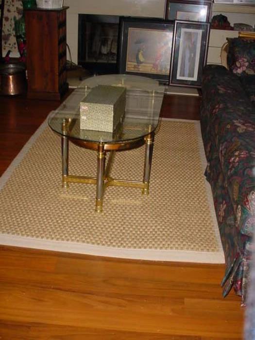 large mat area rug, with brass and glass coffee table