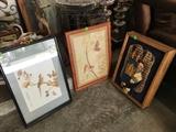 Judaica with music box behind framed art, and two bird pieces.