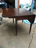 Antique drop leaf table with original casters