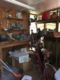 In the tool shed, ladies bicycle, tools, work benches