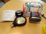 An Aeris Atmos AI Dive Computer. Great working condition. Also a Canon Underwater Proof Camera Case. There's also a Canon G9 camera that fits inside this case.