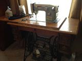Sewing machine with cabinet.