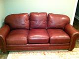 Huffman Koos red/rust leather couch with nail heads. L.88"
