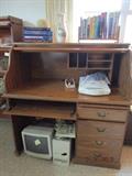 REPLICA ROLLTOP DESK; RELATIVELY NEW. HAS CUT OUT FOR COMPJUTER CORDS; PAPER AND PRINTER DRAWER, KEYBOARD TRAY.. DESK IN GOOD CONDITION....