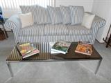 Sofa, chrome and glass top coffee table.