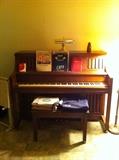 Story & Clark Upright Piano with storage bench filled with vintage sheet music
