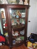 antique tiger oak bow front curio cabinet with carved lion heads and paw feet