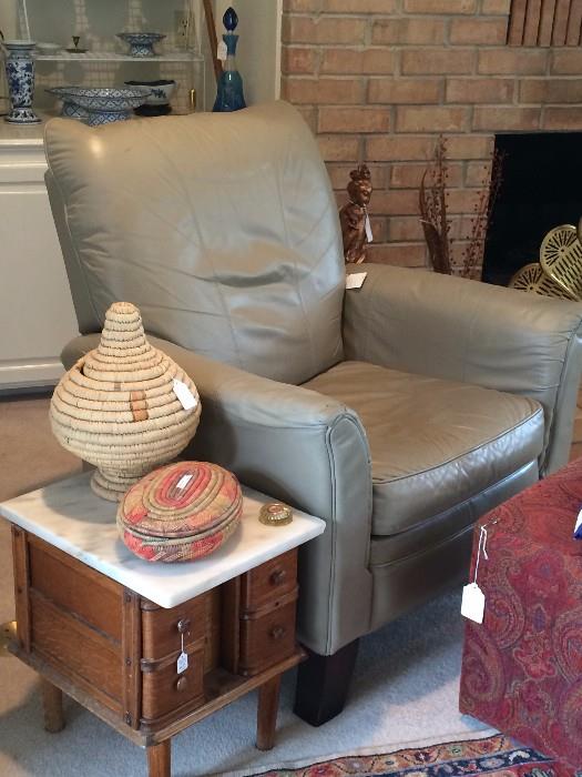 Comfortable recliner; marble top side table; woven baskets