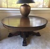 Antique 54" round oak coffee table - it was a dining table that's been cut down.  With bronze color table lamp.