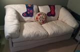 White loveseat - folds out to bed (it's foam - no pesky springs)  Plus needlepoint pillow & cute felt stockings