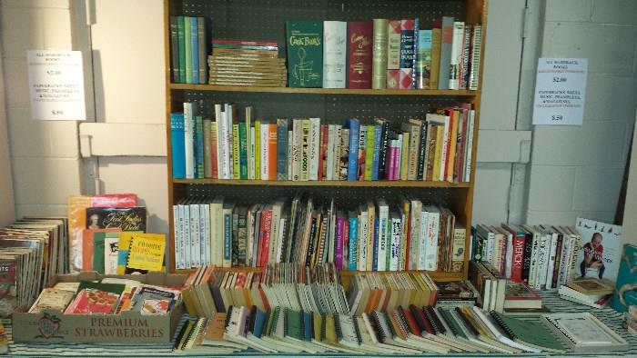 3 tables of cook books, hardback books, paperbacks and reference books