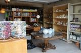Huge amounts of crafting supplies, paints, VHS tapes, dining table, ceramics, glass, candles, bulbs, oak office furniture.