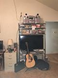 guitar, t.v., chrome shelving, file cabinets, JVC stereo system