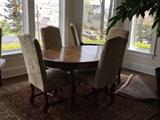 French distressed dining table and 6 custom fabric chairs. 2 leaves included. Also Oriental rug.