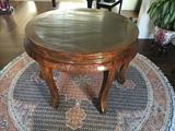 Tall round antique Chinese table and round Asian rug.