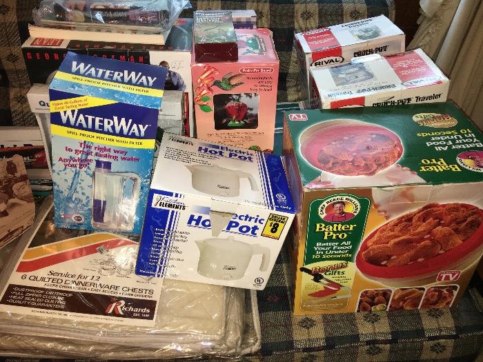 Lots of new-in-box small appliances, cookware and other kitchenry.