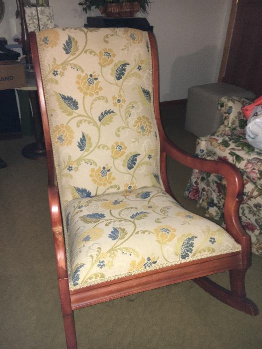 Antique upholstered rocking chair.
