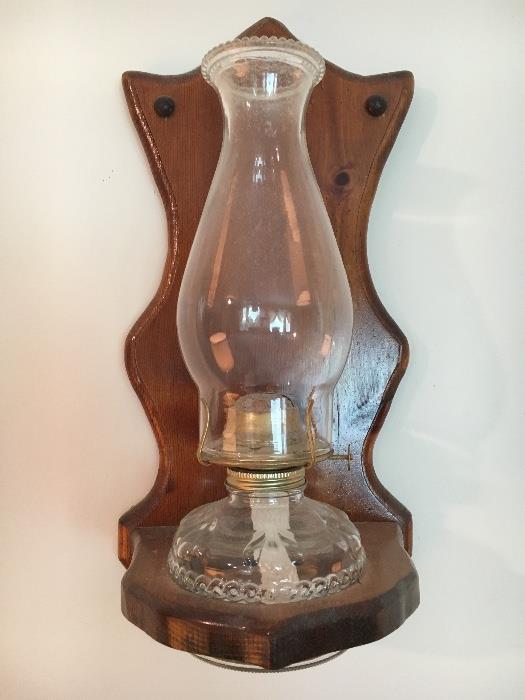 Matching pair oil lamps with hanging wooden holders.