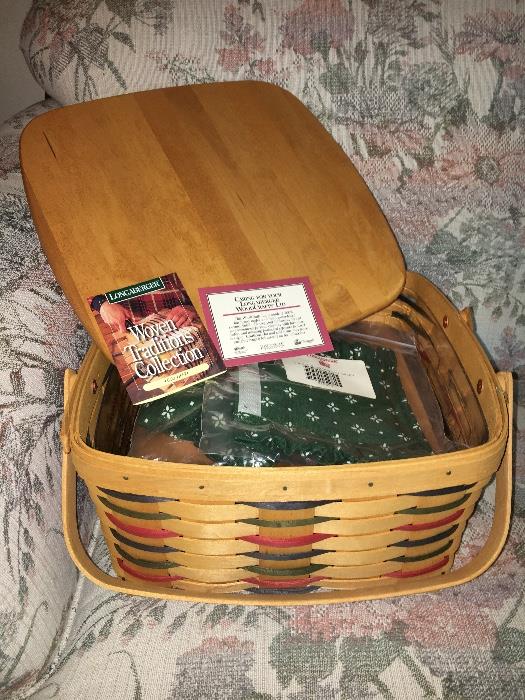 New, unused Longaberger cake basket with riser, plastic liner, fabric liner and lid.
